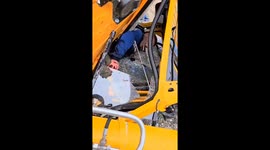 Driver survives crane overturn, requests cigarette while trapped
