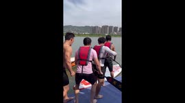 Four guys jump onto paddleboard but fall into river