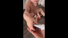 Kid has stolen toothpaste and puts it on French Bulldog secretly