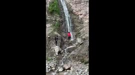 Tourist takes epic selfies under waterfall on Chinese mountain