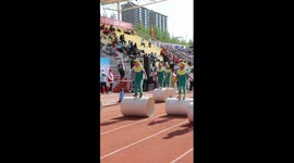 Kids perform walking on cylinder at sports meeting