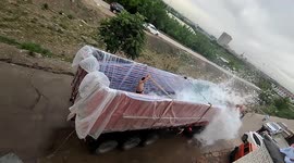 Man narrowly avoids being thrown out of makeshift 'surfing pool' on truck in northern China