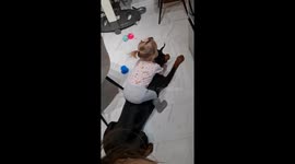A Little Girl Tries to Ride a Doberman