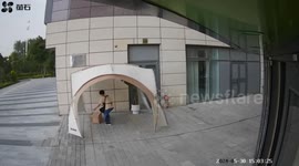 Hilarious moment wind drags man clinging onto heavy street umbrella