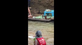Huge cobra terrifies tourists when it emerges on floating raft