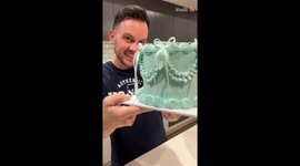 Cake maker connects with his audience while decorating a cake