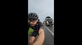 Cyclist Passed By Giant Wind Turbine Blade