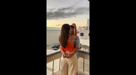 Engagement unfolds against the backdrop of Casa Pueblo's sunset