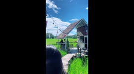 Person falls off path while distracted in Thailand