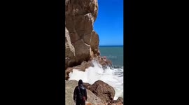 Girl and puppy caught by wave on Crimea's Falcon trail