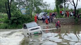 Firefighters save trapped motorist from flooded dam in southern China