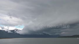 USA: Boat Battles Rainstorm in Stunning Forest Island Scene