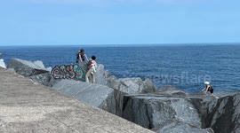 Father told off by coast guard after taking his children on dangerous sea rocks for photo on Spanish coast