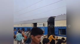 Dozens of passengers push train after fire in India