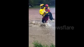 Chinese firefighters save food delivery man trapped in deep floodwaters caused by torrential rain