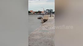 Damaged dam in front of temple collapses
