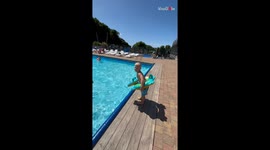 Poolside antics: Little boy's poolside excitement ends in a splashy surprise