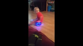 Wheelie woe: Little brother takes a tumble on his sister's hoverboard