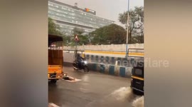 Local cruises down flooded road on a mattress