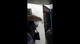 Locals uproot market tent to use as giant umbrella during rainstorm