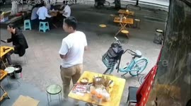 Runaway bike crashes into diners at street restaurant