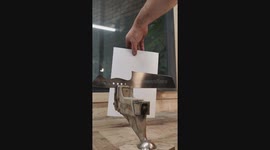 Testing the sharpness of my handmade kitchen knife on a thin piece of paper.