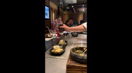 Chef spills bottle of chocolate sauce onto dessert when lid comes off