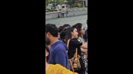 Tourists posing with mouths agape at iconic Merlion statue in Singapore