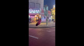 Street performer stuns with impromptu front flip, leaving bystander in awe