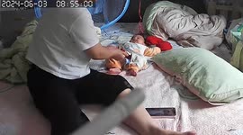Chinese mother's quick reflexes save baby from bedwetting mishap
