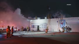 USA: Outside Fire Threatens Auto Shop in Historic South-Central