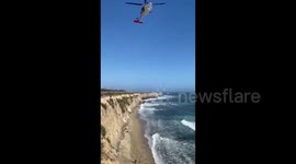 Stranded kite surfer rescued after using rocks to spell