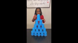 Kids successfully rearrange a cup pyramid into a tall cup tower