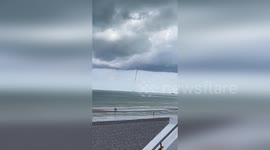 Waterspout tornado swirls off the coast of France