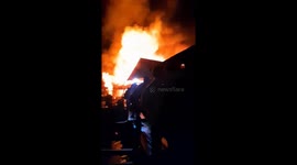 A massive fire destroyed three buildings in the midst of a major flood disaster in Indonesia