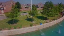 FLAG DAY - Drone Ascends Close to Flag Pole With Dramatic Long Shot Featuring Surrounding Area And Large Flag