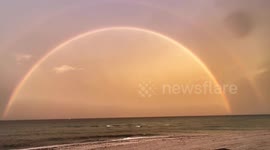 Vibrant Rainbow Over Ocean Beach