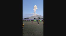 Spectacular moment footballers continue playing as volcano erupts behind them