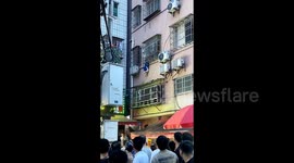Heroic neighbour saves boy dangling from second-floor window in China
