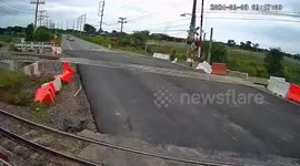 Speeding pickup bounces over crossing railway