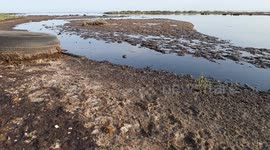 Azerbaijan: Residues of oil pollute the shore near the blue sea