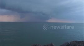 Stormy funnel cloud seen over the Thames Estuary off Kent, UK