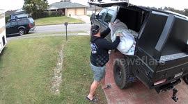 Man shatters window glass while unloading it from his truck