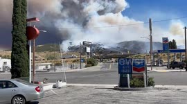 Post Fire, near Los Angeles - a helicopter and a plane drop pink fire retardant