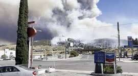 Post Fire, near Los Angeles - a helicopter and a plane drop pink fire retardant