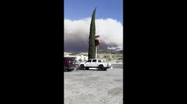 Post Fire, near Los Angeles - a helicopter drops water on the edge of the fire, with huge smoke clouds visible