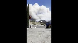 Helicopter circles over massive clouds above Post fire near Los Angeles