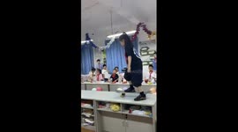 Schoolgirl skater pulls off kick flip in classroom