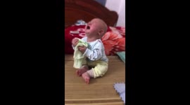 Baby wipes away his tears with handkerchief
