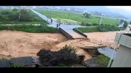 Chinese villager crosses bridge moments before it collapses in floods